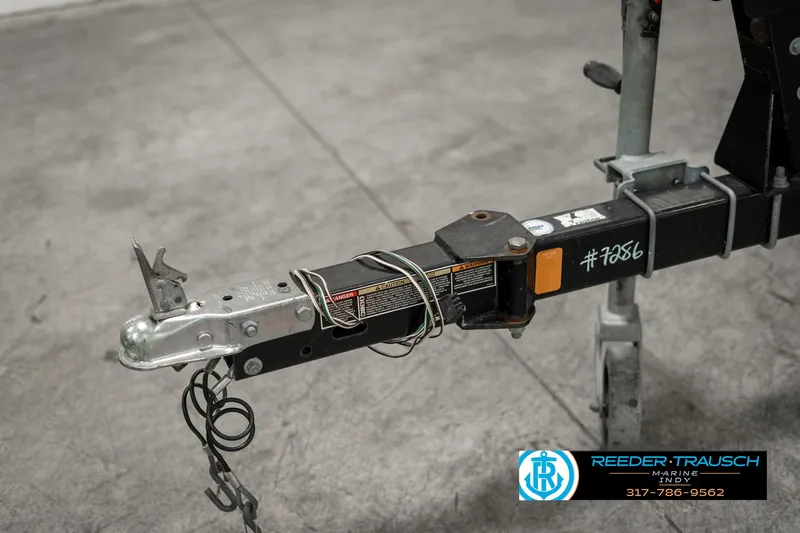 Slide: The Image of Trailer hitch for 2013 Bayliner 175 boat, featuring safety chains and wiring. - 42