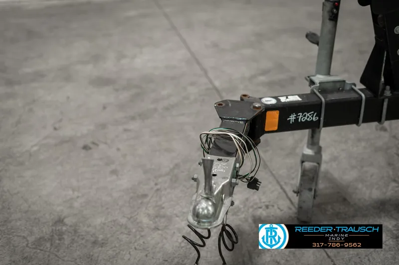 Slide: The Image of Trailer hitch of a 2013 Bayliner 175 boat, displayed in a garage setting. - 43