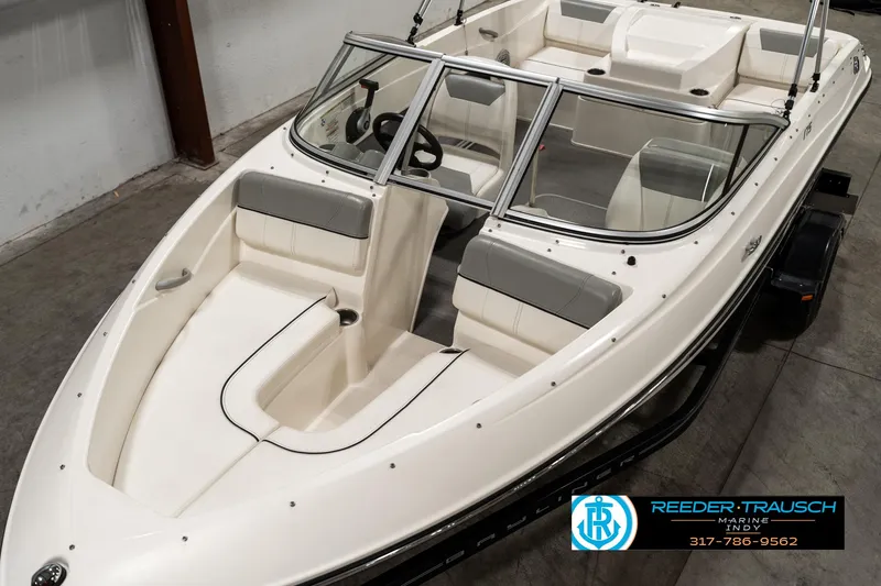 Slide: The Image of 2013 Bayliner 175 boat with white and gray interior, displayed indoors. - 8