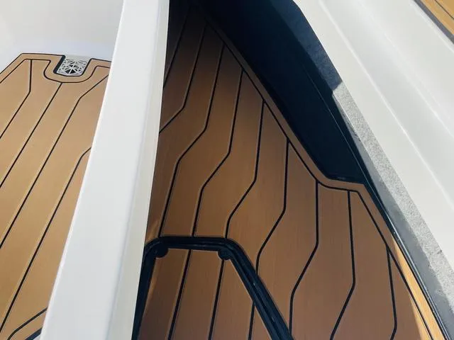 Slide: The Image of 2024 Nautique S23 boat interior with sleek, modern flooring design. - 19
