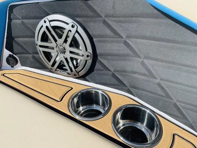 Slide: The Image of 2024 Nautique S23 boat interior with speaker and cup holders. - 21