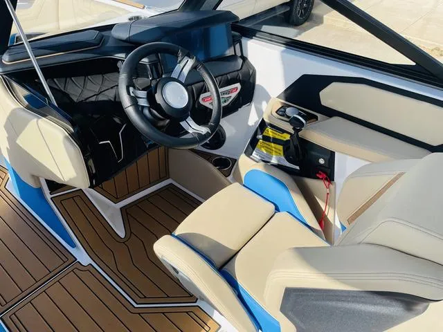Slide: The Image of 2024 Nautique S23 boat interior with modern steering and seating design. - 23