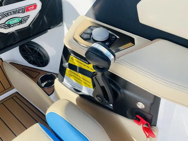 Slide: The Image of 2024 Nautique S23 boat control panel with throttle and warning labels. - 25