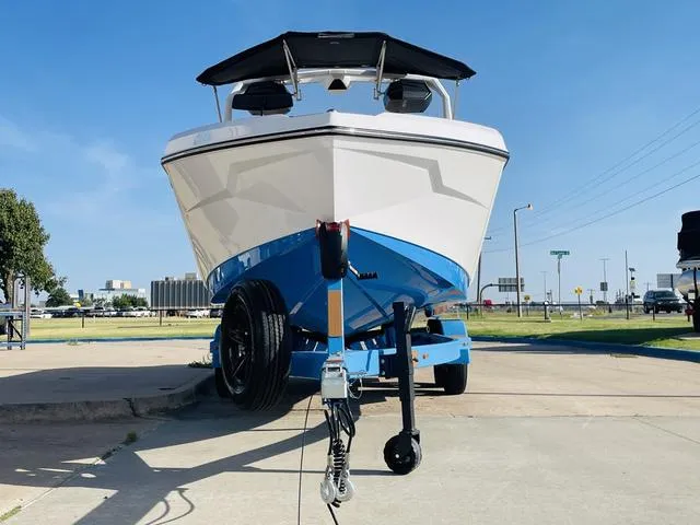 Slide: The Image of 2024 Nautique S23 boat on trailer, front view, sunny day. - 3
