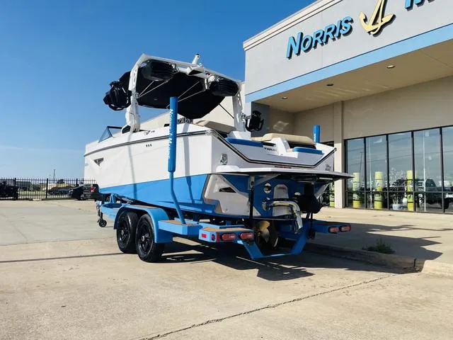 Slide: The Image of 2024 Nautique S23 boat on trailer outside dealership. - 8