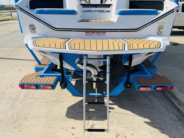 Slide: The Image of 2024 Nautique S23 boat with teak swim platform and ladder. - 9