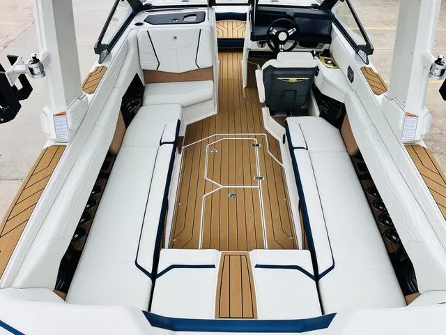 Slide: The Image of 2025 Nautique SUPER AIR G G25 boat interior with luxurious seating and sleek design. - 11