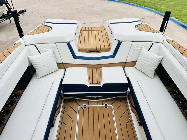 Slide: The Image of Luxurious interior of 2025 Nautique SUPER AIR G G25 boat with white seating and wood accents. - 15