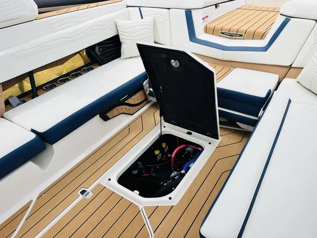 Slide: The Image of 2025 Nautique SUPER AIR G G25 interior with open storage compartment, showcasing luxury seating and design. - 29