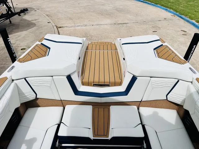 Slide: The Image of 2025 Nautique SUPER AIR G G25 boat interior with white and tan seating. - 31