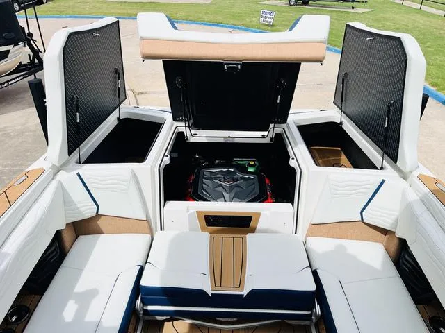 Slide: The Image of 2025 Nautique SUPER AIR G G25 boat interior with open engine compartment. - 36