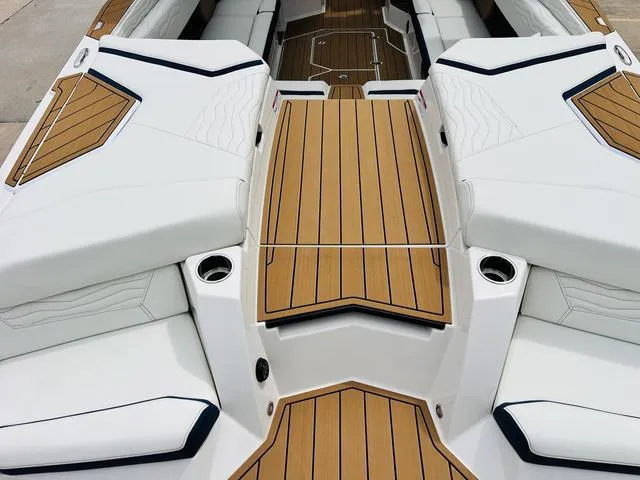 Slide: The Image of 2025 Nautique SUPER AIR G G25 boat interior with sleek white and wood design. - 40