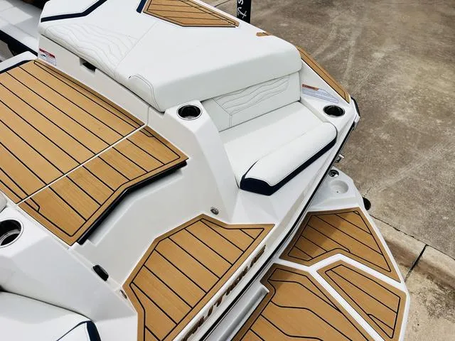 Slide: The Image of 2025 Nautique SUPER AIR G G25 boat with sleek deck design and cushioned seating. - 41
