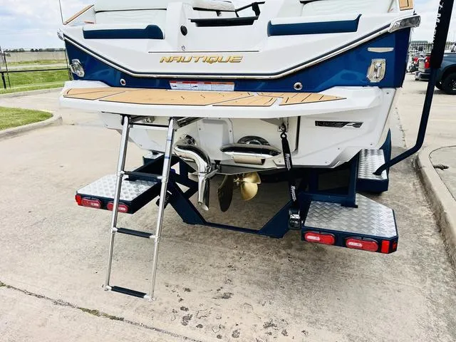Slide: The Image of 2025 Nautique SUPER AIR G G25 boat rear view with swim platform and ladder. - 9
