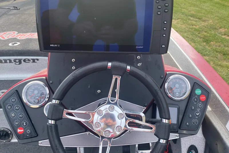 Slide: The Image of 2015 Ranger Z520C boat dashboard with steering wheel and electronic display. - 5