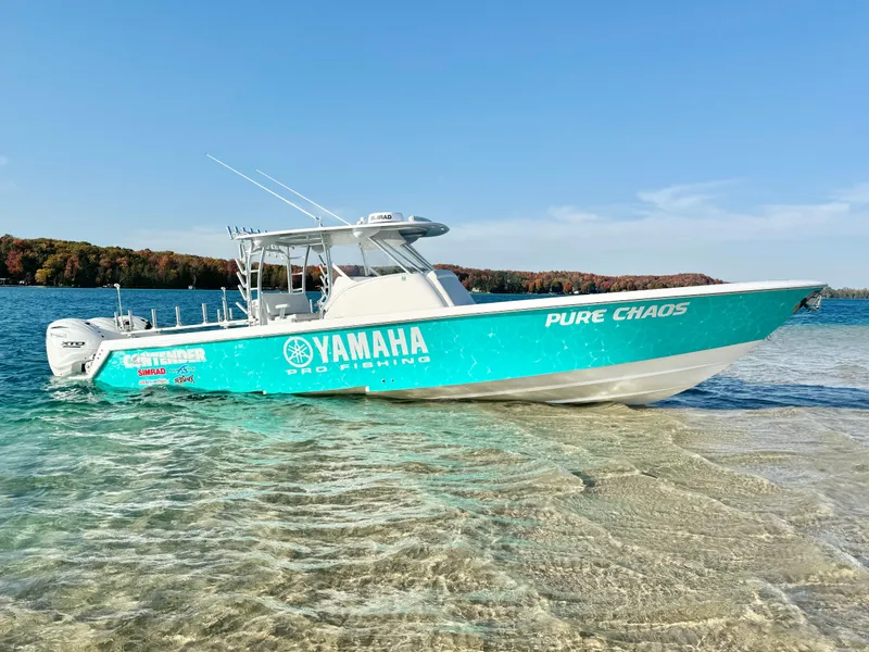 Slide: The Image of 2024 Contender 39 Fisharound boat in turquoise, docked on clear water. - 3