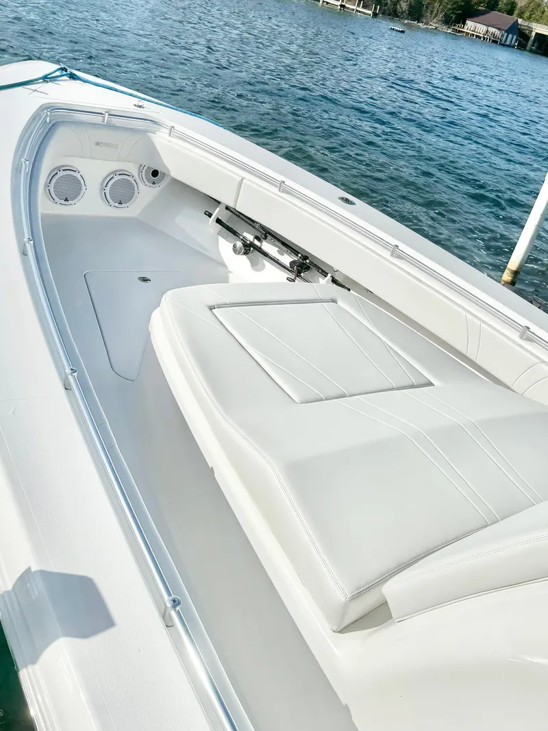 Slide: The Image of 2024 Contender 39 Fisharound boat interior with white seating and ocean view. - 4