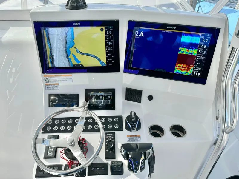 Slide: The Image of 2024 Contender 39 Fisharound helm with dual navigation screens and controls. - 5