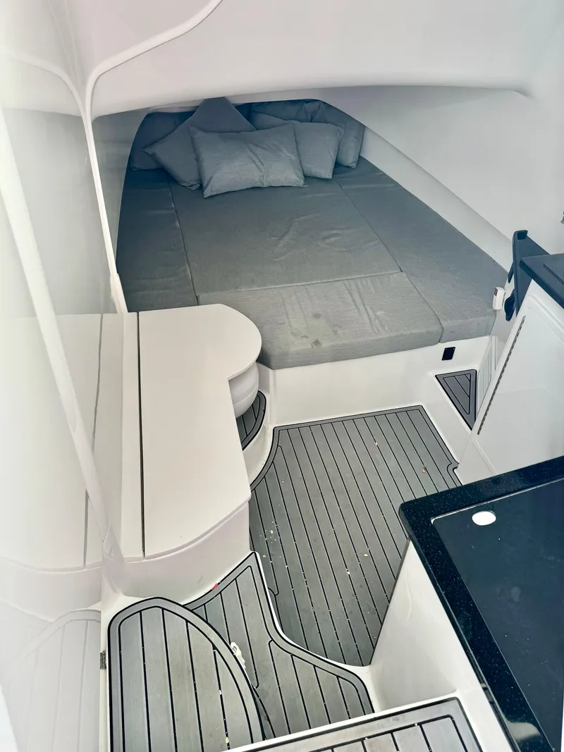 Slide: The Image of 2024 Contender 39 Fisharound cabin with bed and modern interior design. - 6