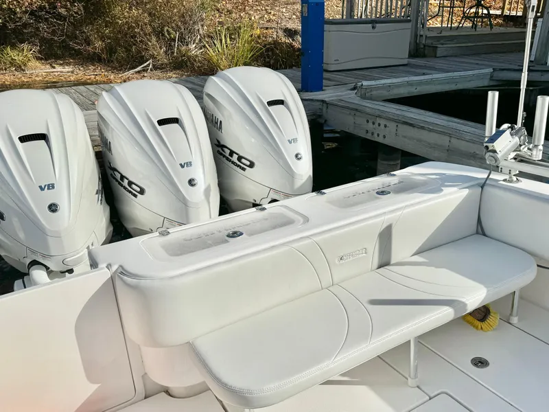 Slide: The Image of 2024 Contender 39 Fisharound with triple Yamaha V8 outboard engines at dock. - 7