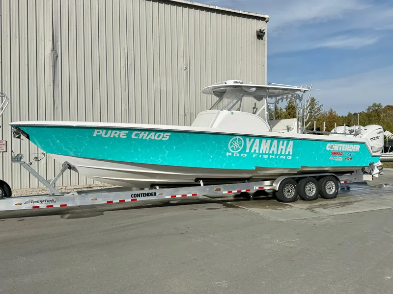 Slide: The Image of 2024 Contender 39 Fisharound boat on trailer, featuring Yamaha branding. - 8