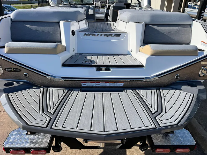 Slide: The Image of 2024 Nautique G25 boat with sleek gray deck and comfortable seating. - 10
