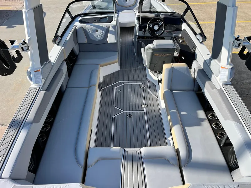 Slide: The Image of 2024 Nautique G25 boat interior with sleek seating and modern dashboard design. - 12
