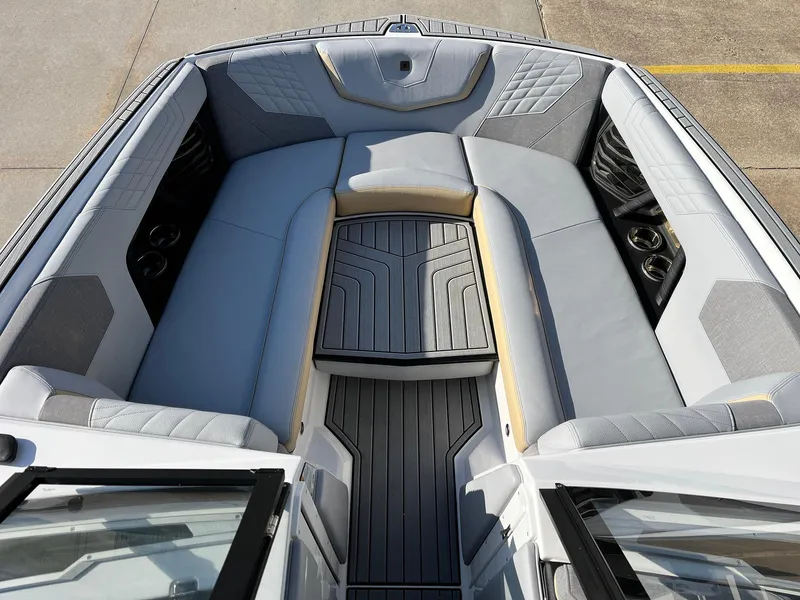 Slide: The Image of 2024 Nautique G25 boat interior with spacious, cushioned seating and sleek design. - 14