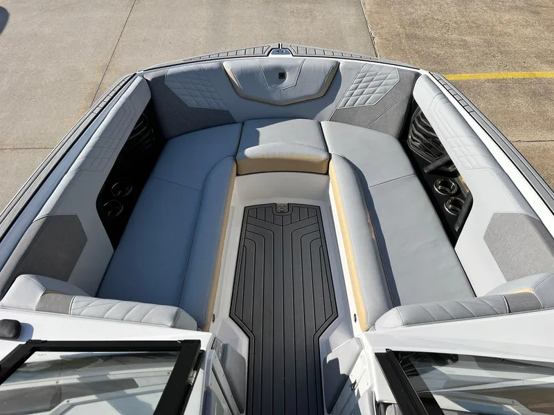 Slide: The Image of 2024 Nautique G25 boat interior with gray seating and modern design. - 15