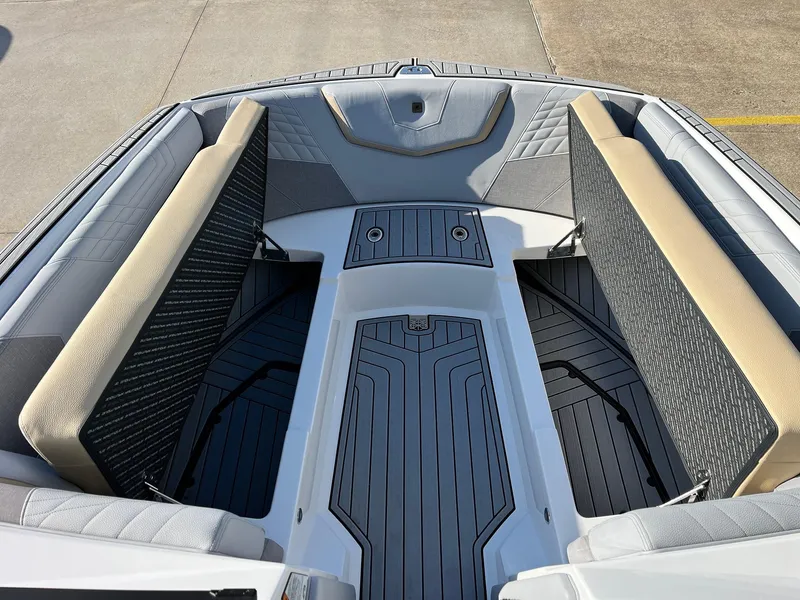 Slide: The Image of 2024 Nautique G25 boat interior with cushioned seating and sleek design. - 21