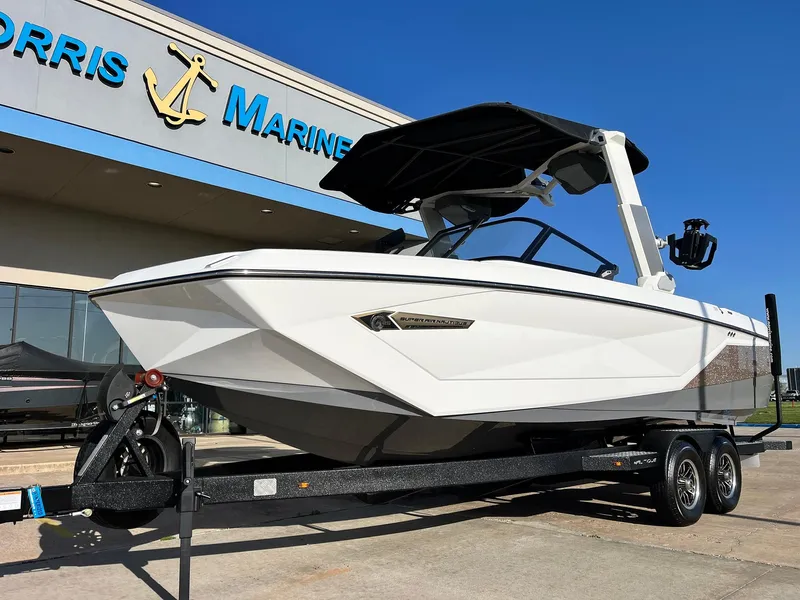 Slide: The Image of 2024 Nautique G25 boat on trailer outside Morris Marine dealership. - 3