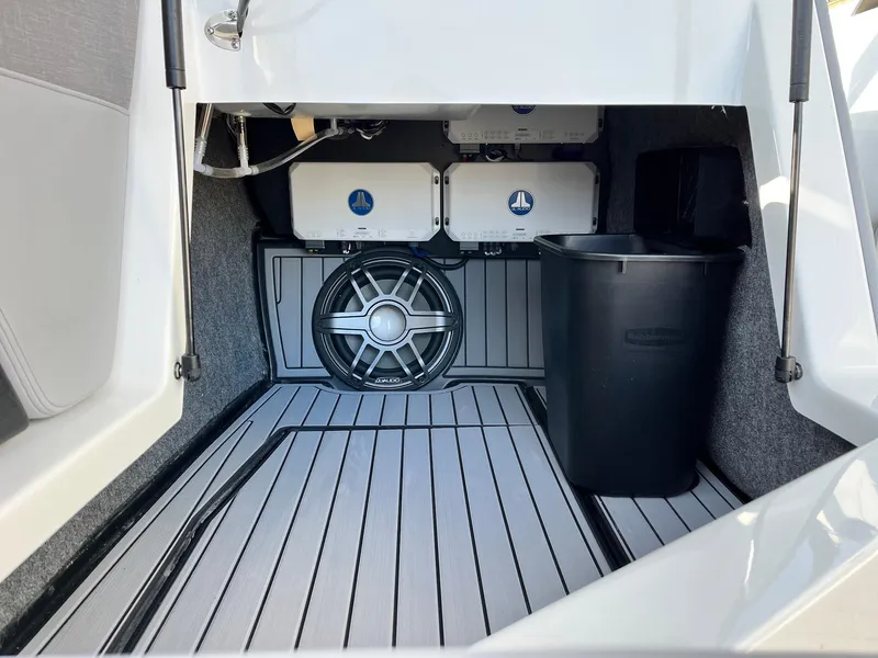 Slide: The Image of 2024 Nautique G25 storage area with speaker and equipment. - 32