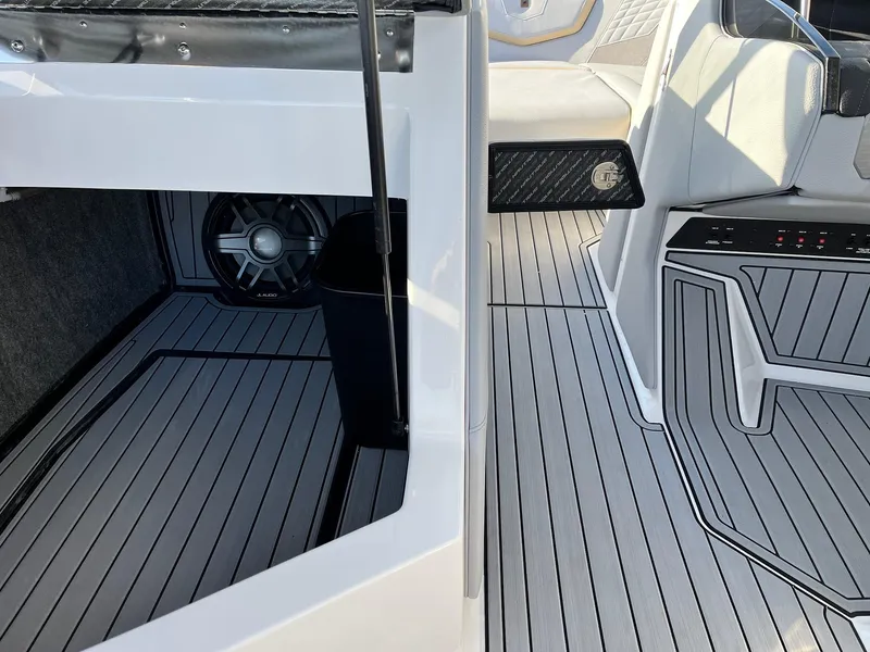 Slide: The Image of 2024 Nautique G25 boat interior with sleek flooring and modern design elements. - 34