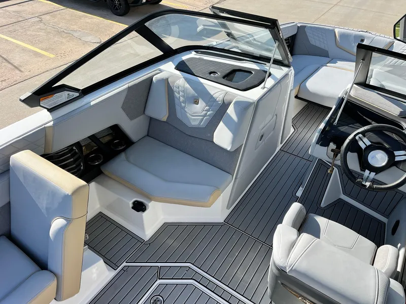 Slide: The Image of 2024 Nautique G25 boat interior with sleek seating and modern dashboard design. - 37