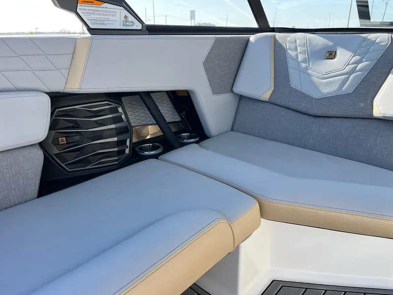 Slide: The Image of 2024 Nautique G25 interior with luxurious seating and premium audio system. - 42