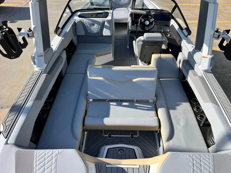 Slide: The Image of 2024 Nautique G25 boat interior with luxurious seating and modern dashboard design. - 46