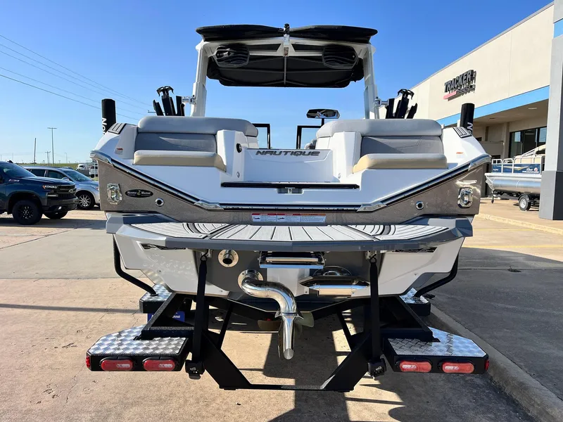 Slide: The Image of 2024 Nautique G25 boat rear view at dealership, showcasing sleek design and features. - 7