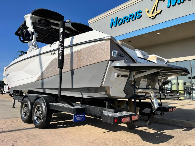 Slide: The Image of 2024 Nautique G25 boat on trailer at Norris Marine dealership. - 8