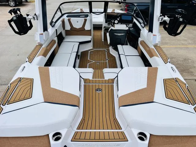 Slide: The Image of 2024 Nautique G23 boat interior with luxurious seating and teak flooring. - 10