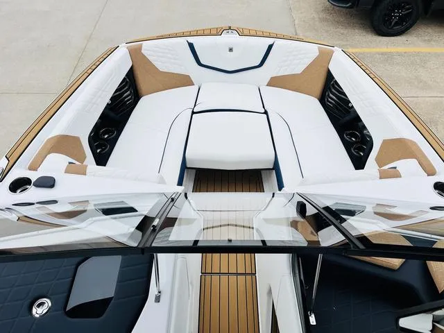 Slide: The Image of 2024 Nautique G23 boat interior with white and tan seating, sleek design. - 12