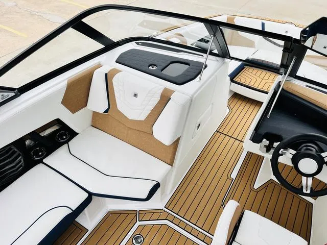 Slide: The Image of 2024 Nautique G23 boat interior with sleek seating and modern dashboard design. - 17