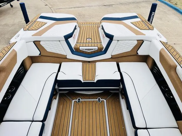 Slide: The Image of 2024 Nautique G23 boat interior with luxurious white and tan seating. - 19