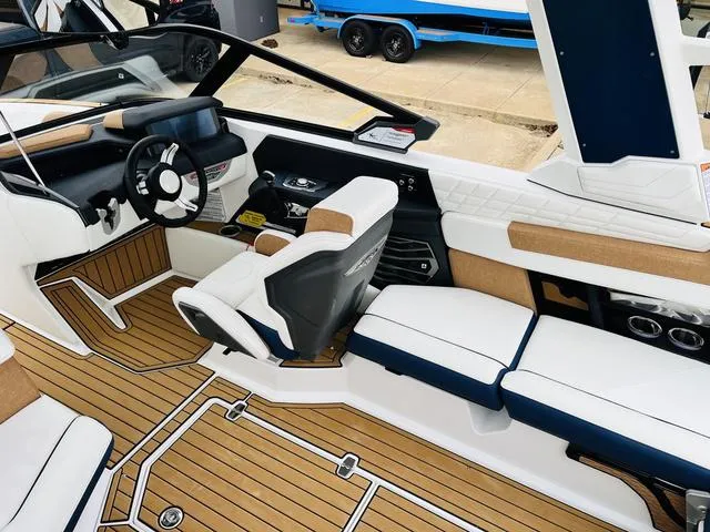 Slide: The Image of 2024 Nautique G23 boat interior with modern seating and sleek dashboard design. - 21