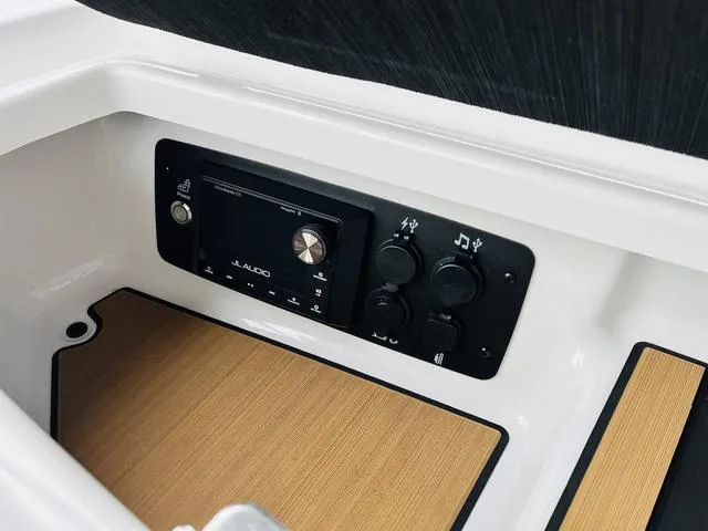 Slide: The Image of 2024 Nautique G23 audio control panel with JL Audio system. - 24