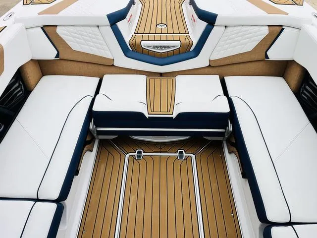 Slide: The Image of Luxurious interior of 2024 Nautique G23 boat with elegant seating and teak flooring. - 32