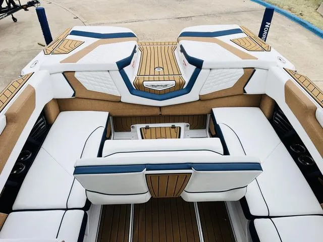 Slide: The Image of Luxurious interior of 2024 Nautique G23 boat with white and tan seating. - 34