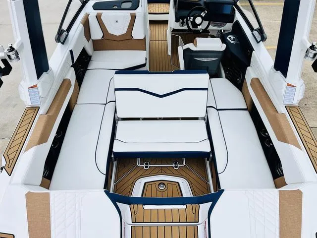 Slide: The Image of 2024 Nautique G23 boat interior with white and tan seating, modern design, and spacious layout. - 35