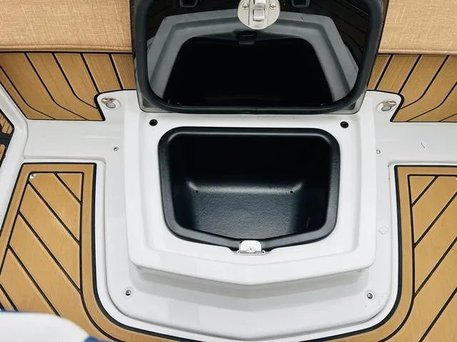 Slide: The Image of 2024 Nautique G23 storage compartment with teak flooring. - 37