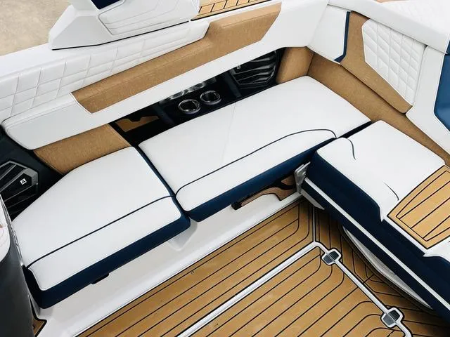 Slide: The Image of Luxurious interior of 2024 Nautique G23 boat with white and tan seating. - 38