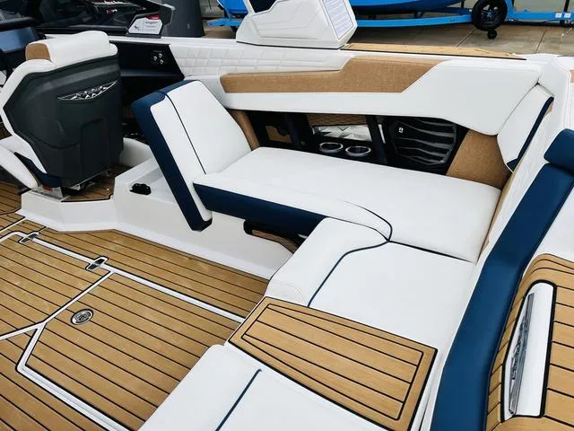Slide: The Image of 2024 Nautique G23 boat interior with luxurious seating and teak flooring. - 40